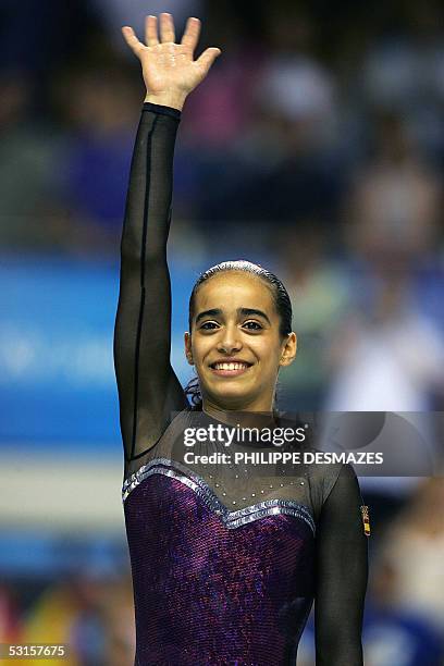 Spanish Tania Gener Cordero salutes thr audience after winning the women's uneven bars gymnastics final of the XV Mediterranean Games, 27 June 2005...