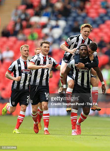 Omar Bogle of Grimsby Town is mobbed by team mates after scoring the opening goal during the Vanarama Football Conference League: Play Off Final...