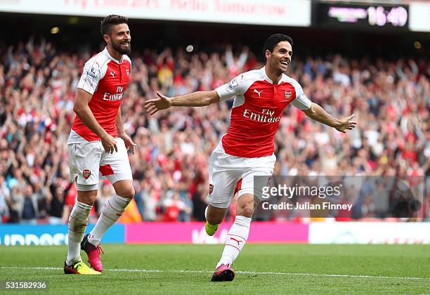 Mikel Arteta and Olivier Giroud of Arsenal celebrate their team's fourth goal scored own goal by Mark Bunn of Aston Villa during the Barclays Premier...