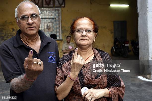 An elderly woman shows her ink marked finger after casting vote during Delhi Municipal bypolls, on May 15, 2016 in New Delhi, India. Voting began on...