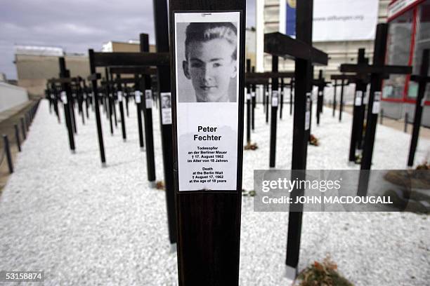 File picture taken on 11 April 2005 shows a portrait of a victim of the Berlin wall attached to a cross at a memorial dedicated to the 1065 people...