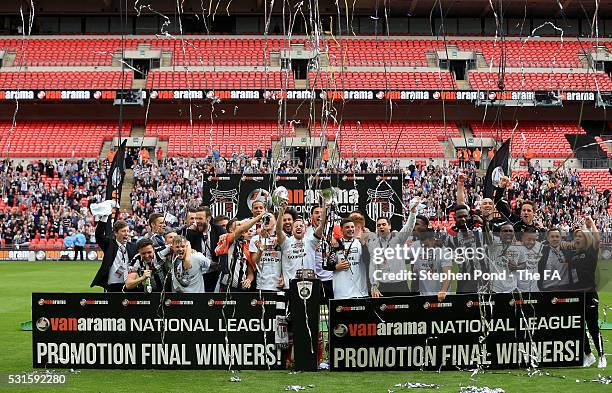 Grimsby Town players celebrate victory with the trophy during the Vanarama Football Conference League: Play Off Final match between Forest Green...