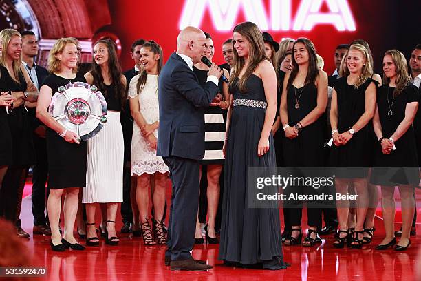 Melanie Leupolz of FC Bayern Muenchen women team is interviewsd by speaker Stefan Lehmann during the Bundesliga Champions Dinner at the Postpalast on...