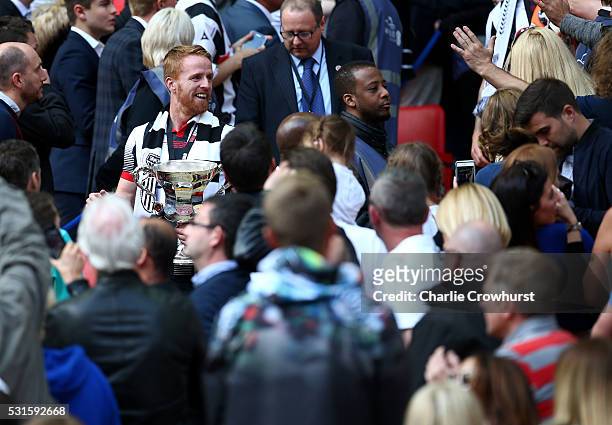 Grimsby's Craig Disley walks down to the pitch with the trophy as he celebrates the teams win and promotion to the football league during the...