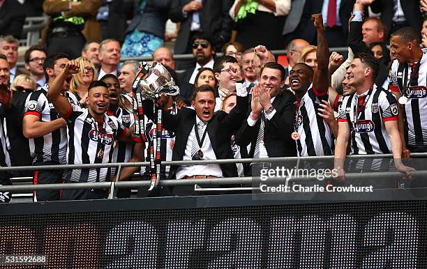 Grimsby's manager Paul Hurst lifts the trophy as he celebrates the teams win and promotion to the football league during the Vanarama Football...