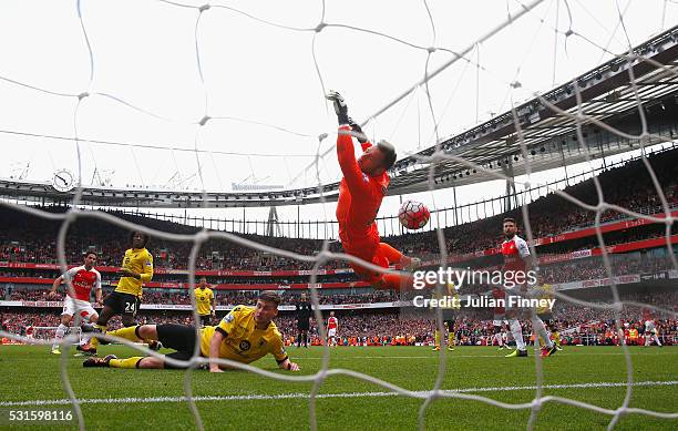 Mikel Arteta of Arsenal shot hits the cross bar which rebounds off Mark Bunn of Aston Villa for their fourth goal during the Barclays Premier League...