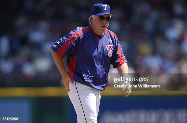 Manager Buck Showalter of the Texas Rangers looks to the dugout as he leaves the field after making a pitching change during the game against the...