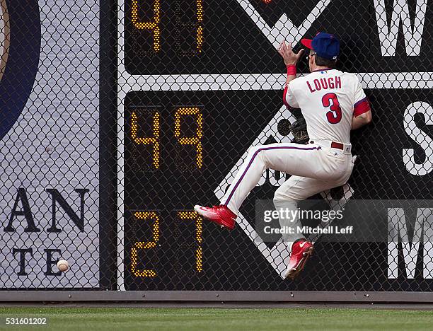 David Lough of the Philadelphia Phillies hits the wall trying to catch a ball hit by Jay Bruce of the Cincinnati Reds in the top of the second inning...