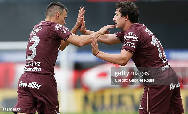 Maximiliano Velazquez of Lanus celebrates with teammate Nicolas Aguirre after scoring the opening goal during a match between Argentinos Juniors and...