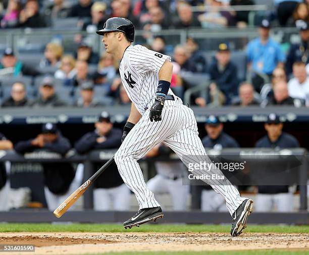 Dustin Ackley of the New York Yankees walks with the bases loaded to score Carlos Beltran in the third inning against the Chicago White Sox at Yankee...