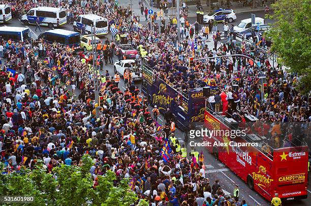Barcelona players celebrate on an open top bus during their victory parade after winning the Spanish La Liga on May 15, 2016 in Barcelona, Spain.