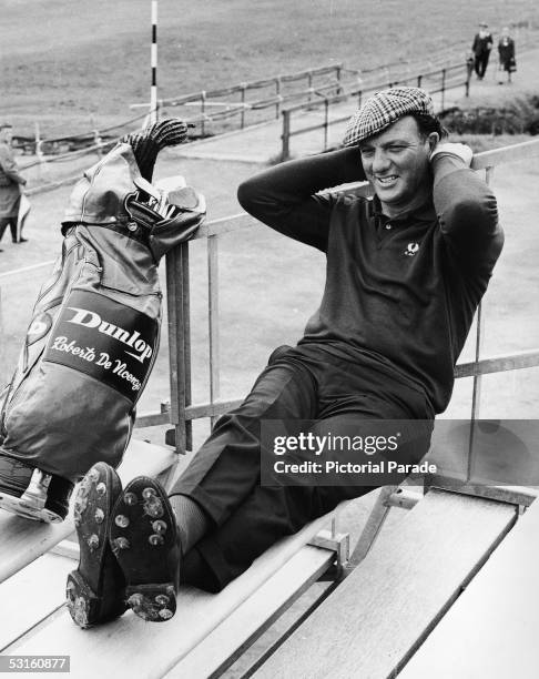 Argentinian professional golfer and British Open defending champion Roberto DeVicenzo takes a break on the steps of a player's hut at the Carnoustie...