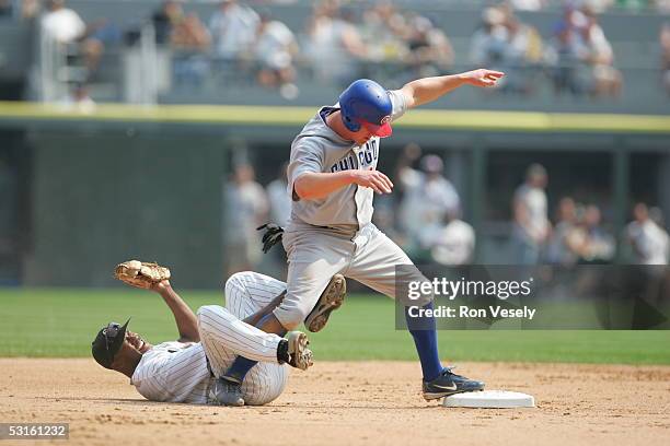 Jeromy Burnitz of the Chicago Cubs knocks over Willie Harris while stealing second base in the 7th inning during the game against the Chicago White...