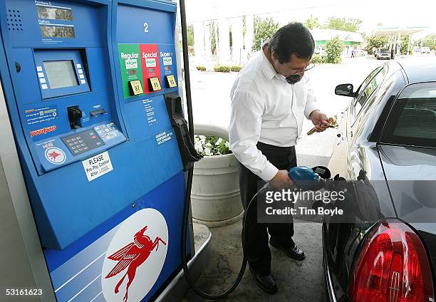 Limousine driver Maitham Natour fills his tank at a Mobil gas station June 28, 2005 in Des Plaines, Illinois. The recent surge in oil and related...