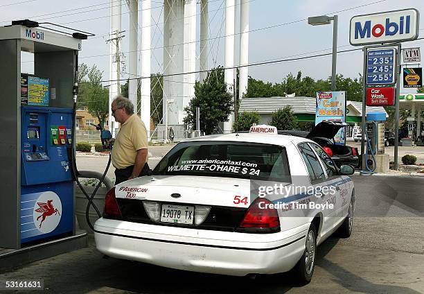 Taxi cab driver Chet Nichols fills his tank at a Mobil gas station June 28, 2005 in Des Plaines, Illinois. The recent surge in oil and related...