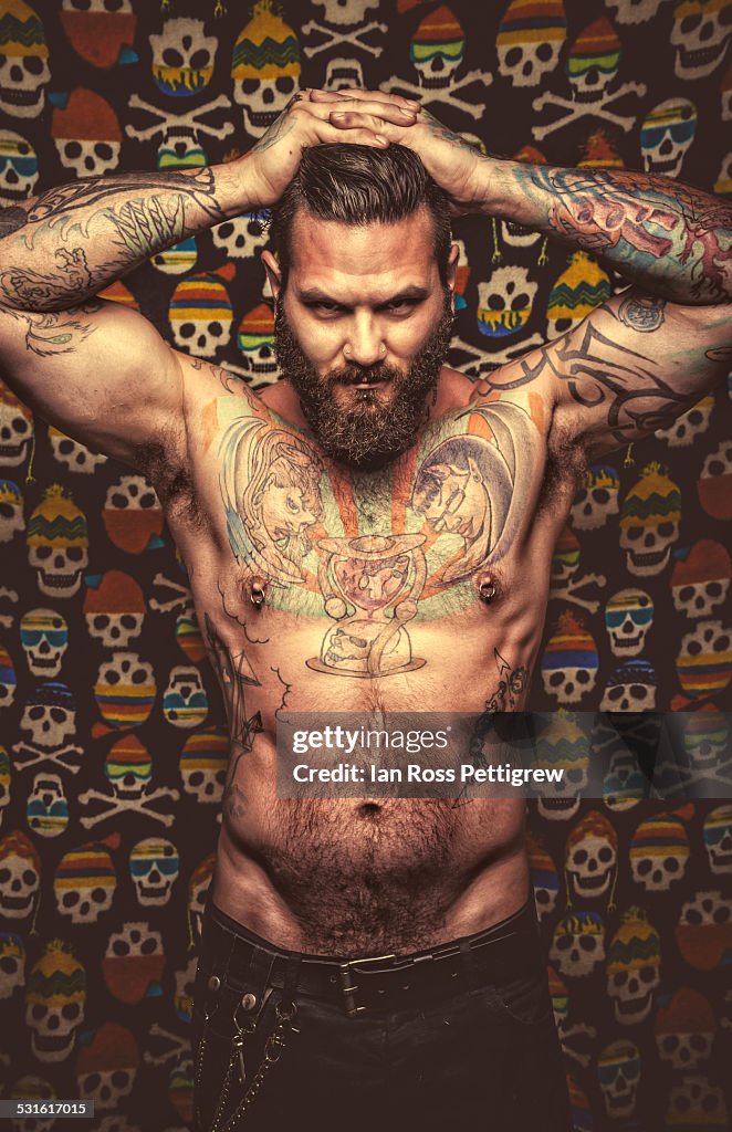 Male model posing on skull background