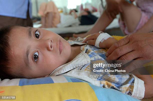 Young boy sickened during a vaccine accident undergoes treatment at a local hospital on June 28, 2005 in Sixian County of Anhui Province, east China....