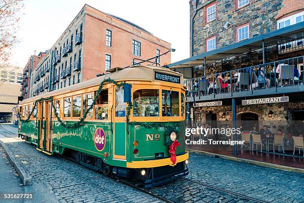 savannah riverfront with streetcar - savannah stock pictures, royalty-free photos & images