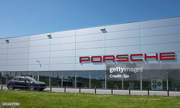 porsche dealership with a porsche macan suv - jeep type stock pictures, royalty-free photos & images