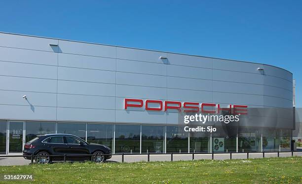 porsche dealership with a porsche macan suv - jeep type stock pictures, royalty-free photos & images