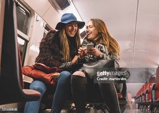 women laughing in the subway - french culture stock pictures, royalty-free photos & images