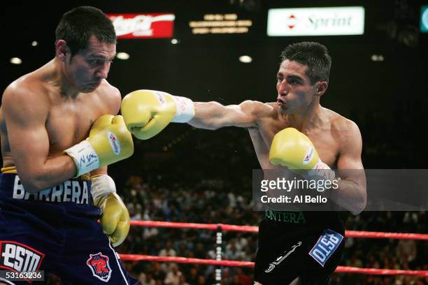 Erik Morales throws a right cross against Marco Antonio Barrera during the WBC World Super Featherweight Championship at the MGM Grand Garden Arena...