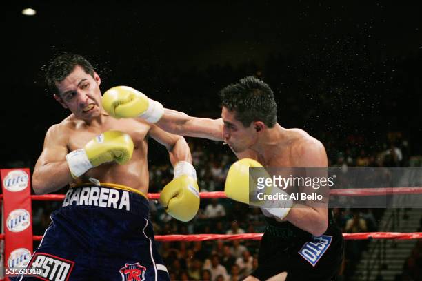 Erik Morales lands a right hand to the head of Marco Antonio Barrera during the WBC World Super Featherweight Championship at the MGM Grand Garden...