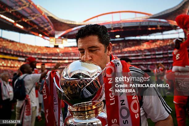 Benfica's head coach Rui Vitoria kisses the trophy as he celebrates Benfica's 35th Portuguese league title at the end of the Portuguese league...