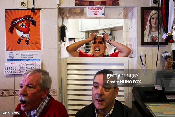 Benfica supporters watch the Portuguese League football match SL Benfica vs CD Nacional on television at "A Ginginha" restaurant in downtown Lisbon...