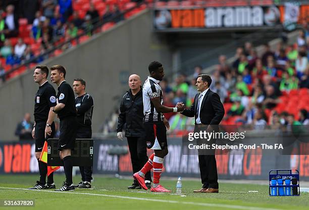 Manager Paul Hurst embraces Omar Bogle of Grimsby Town after substituting him during the Vanarama Football Conference League: Play Off Final match...