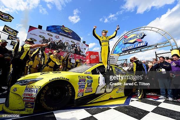 Matt Kenseth, driver of the Dollar General Toyota, celebrates in Victory Lane after winning the NASCAR Sprint Cup Series AAA 400 Drive for Autism at...