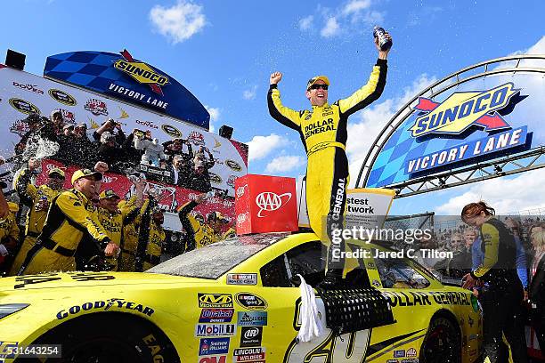 Matt Kenseth, driver of the Dollar General Toyota, celebrates in Victory Lane after winning the NASCAR Sprint Cup Series AAA 400 Drive for Autism at...