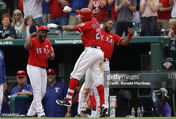 Ian Desmond of the Texas Rangers celebrates his three-run homerun with Elvis Andrus in the seventh inning against the Toronto Blue Jays at Globe Life...