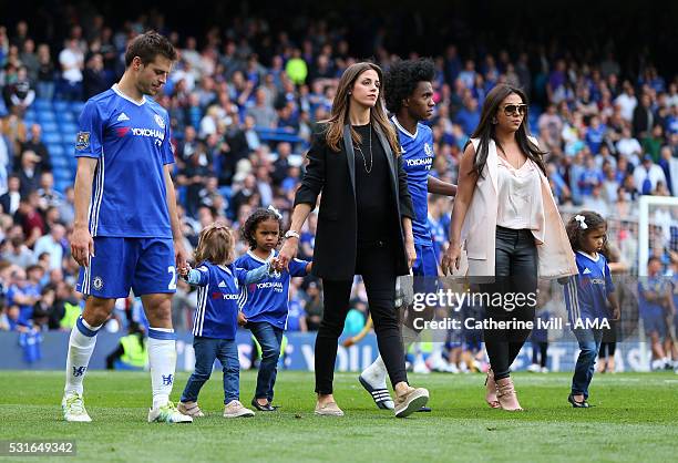 Cesar Azpilicueta of Chelsea with daughter Martina and wife Adriana walk alongside Willian of Chelsea with wife Vanessa Martins and daughters...