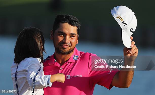 Jason Day of Australia celebrates with son Dash after winning during the final round of THE PLAYERS Championship at the Stadium course at TPC...