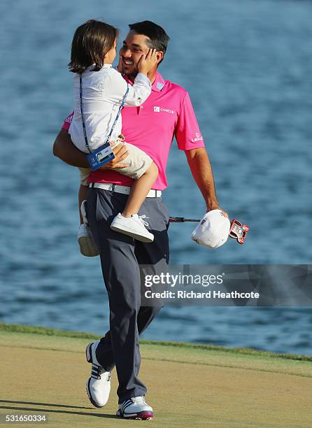 Jason Day of Australia celebrates with son Dash after winning during the final round of THE PLAYERS Championship at the Stadium course at TPC...