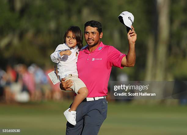 Jason Day of Australia celebrates with son Dash after winning during the final round of THE PLAYERS Championship at the Stadium course at TPC...