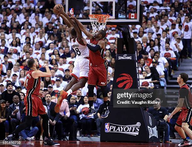 Bismack Biyombo of the Toronto Raptors dunks the ball over Dwyane Wade of the Miami Heat late in the second half of Game Seven of the Eastern...