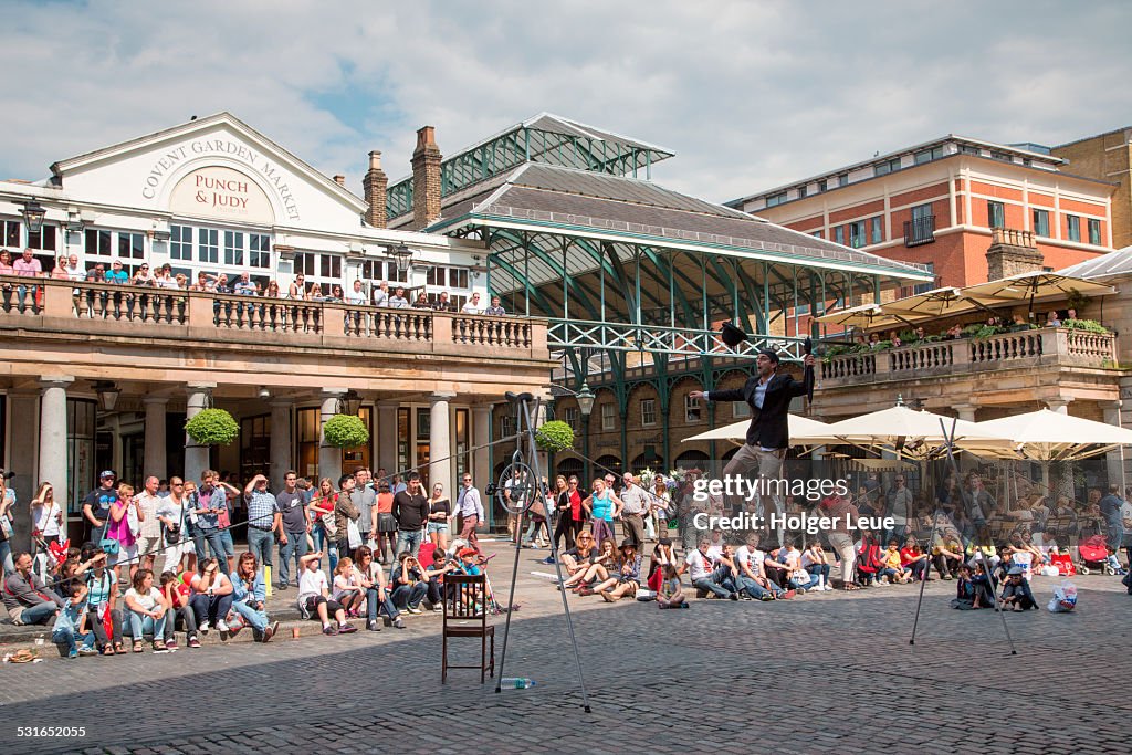 Busker performs outside Covent Garden Market