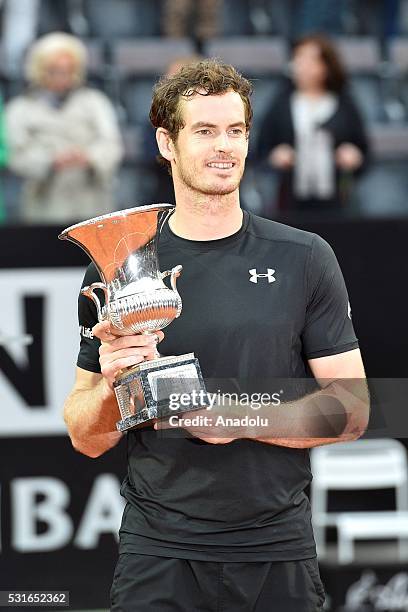 Andy Murray of Great Britain poses with his trophy after winning the Men's Singles Final match against Novak Djokovic during day eight of The...