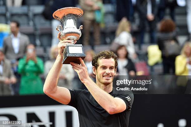 Andy Murray of Great Britain poses with his trophy after winning the Men's Singles Final match against Novak Djokovic during day eight of The...