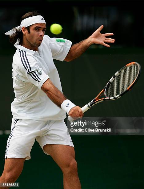 Fernando Gonzalez of Chile in action against Roger Federer of Switzerland in the Gentlemen?s Singles during the ninth day of the Wimbledon Lawn...