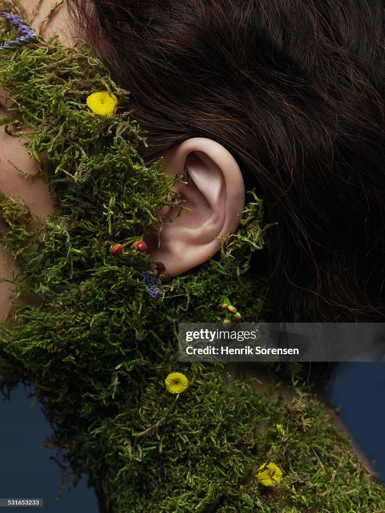 Woman with moss on her neck