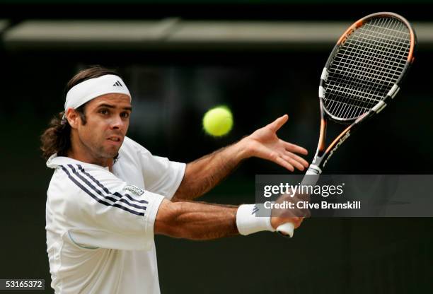 Fernando Gonzalez of Chile in action against Roger Federer of Switzerland in the Gentlemen?s Singles during the ninth day of the Wimbledon Lawn...