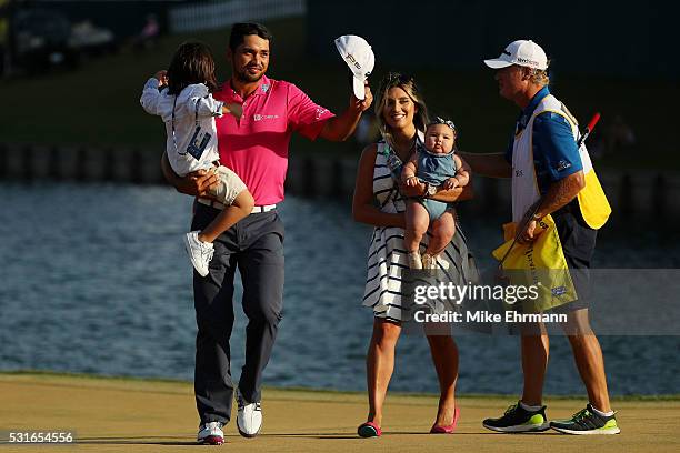 Jason Day of Australia celebrates with son Dash, wife Ellie and daughter Lucy and caddie Colin Swatton after winning during the final round of THE...