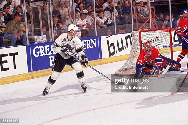 Canadian professional hockey player Patrick Roy goaltender for the Montreal Canadiens makes a save against Wayne Gretzky of the Los Angeles Kings as...