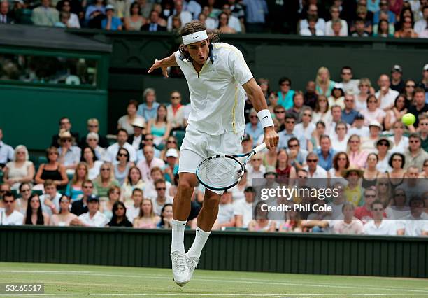 Feliciano Lopez of Spain in action against Lleyton Hewitt of Australia in the Gentlemen?s Singles during the ninth day of the Wimbledon Lawn Tennis...