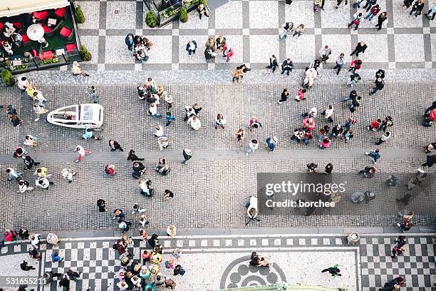 people walking on old town square in prague - prague people stock pictures, royalty-free photos & images