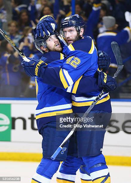 David Backes of the St. Louis Blues celebrates with Jaden Schwartz after scoring a first period goal against Martin Jones of the San Jose Sharks in...