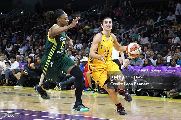 Ana Dabovic of the Los Angeles Sparks handles the ball against Monica Wright of the Seattle Storm during a WNBA basketball game at Staples Center on...